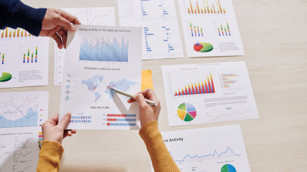 Hands of businessman giving document with website visiting activity chart to coworker